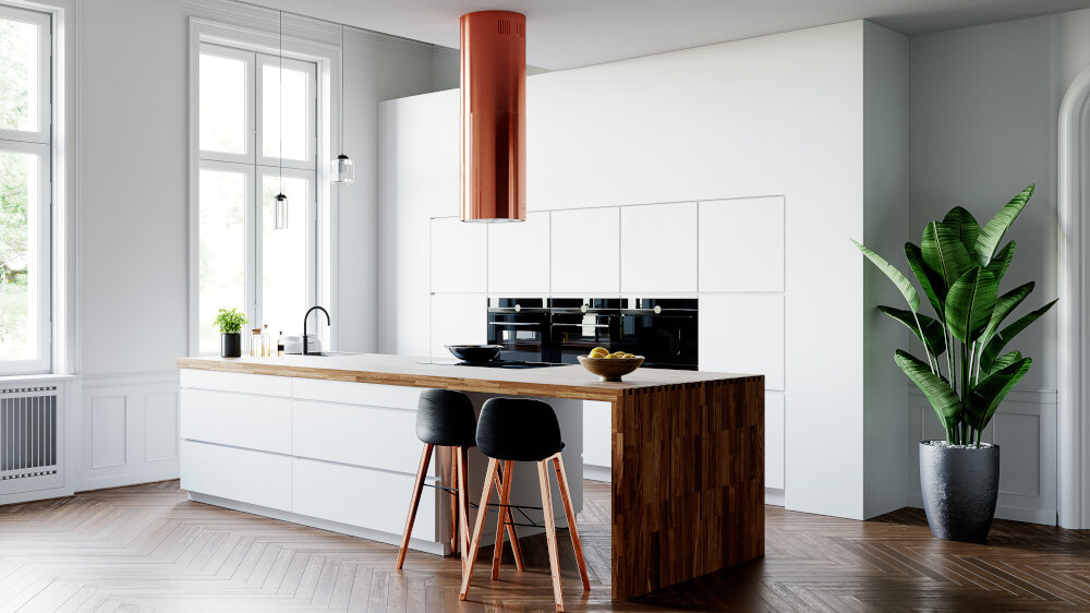 OKAP GLOBALO CYLINDRO ISOLA 39.7 MIEDŹ Zdjęcie przedstawia jasną kuchnię z wyspą, przy której ustawiony jest okrągły stół i cztery różnokolorowe krzesła. Na ścianie wiszą cztery ramki ze zdjęciami, a w tle widać elementy dekoracyjne oraz rośliny. Kuchnia posiada szafki w jasnych barwach, ciemny blat oraz miedziany okap nad wyspą. Po prawej stronie znajduje się przestronny salon z szarą kanapą i dużym obrazem na ścianie.