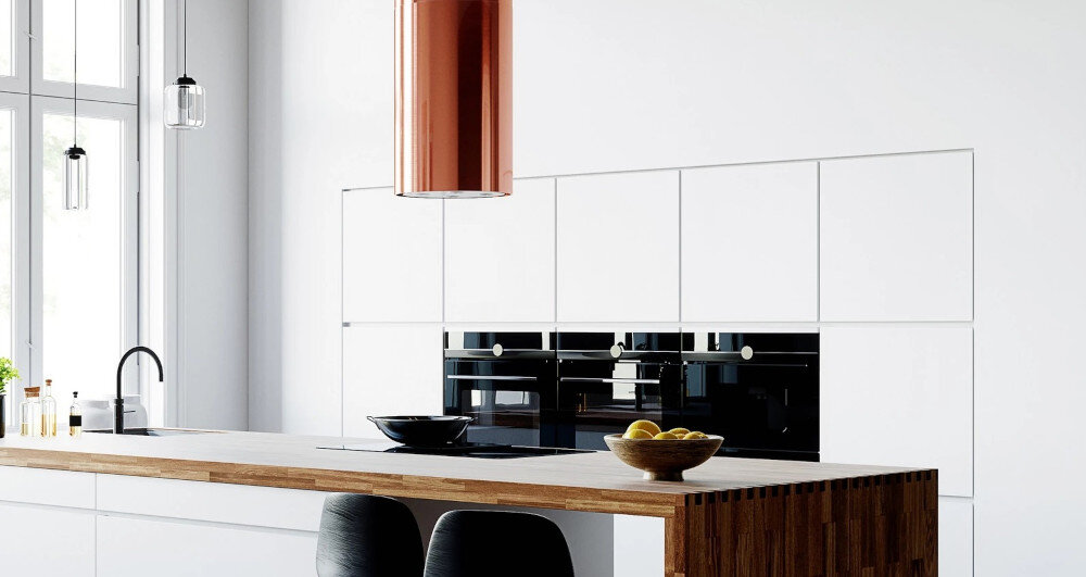 OKAP GLOBALO CYLINDRO ISOLA 39.7 MIEDŹ Zdjęcie przedstawia kuchnię z wyspą wyposażoną w płytę grzewczą. Nad wyspą zamontowany jest okap w kształcie miedzianej tuby z czterema wbudowanymi lampkami LED. W centralnym miejscu na wyspie stoi roślina w doniczce, a w tle widać eleganckie, połyskujące szafki oraz detale kuchenne. Całość utrzymana jest w jasnej, minimalistycznej aranżacji z kontrastowym miedzianym akcentem wyspowy globalo miedziany stal szlachetna tuba kuchenny sufitowy design premium wyspa cylindryczny elegancki kuchnia agd wydajny dekoracyjny