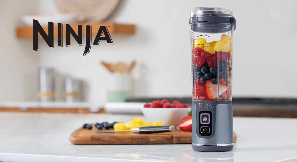 Blender personalny NINJA Blast BC151EUNV Niebieski Bezprzewodowy efektywne miksowanie blender w kolorze niebieskim stoi na blacie owoce wewnątrz pojemnika przyciski na obudowie