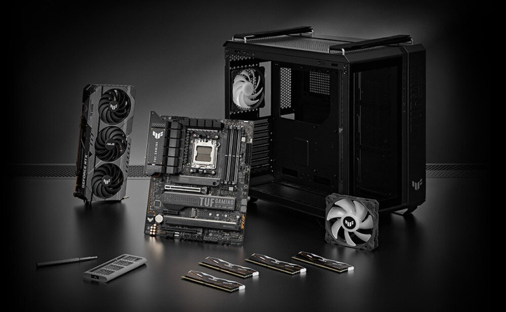 Płyta główna ASUS TUF Gaming B650-E WiFi zestaw podzespołów komputerowych na czarnym tle: płyta główna, karta graficzna, obudowa, wentylatory i moduły pamięci RAM