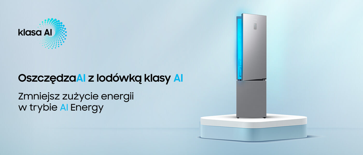Obraz przedstawia lodówkę w kolorze szczotkowanej stali nierdzewnej na białym postumencie. Tekst na obrazie: \'klasa AI Oszczędzaj z lodówką klasy AI Zmniejsz zużycie energii w trybie AI Energy\'.