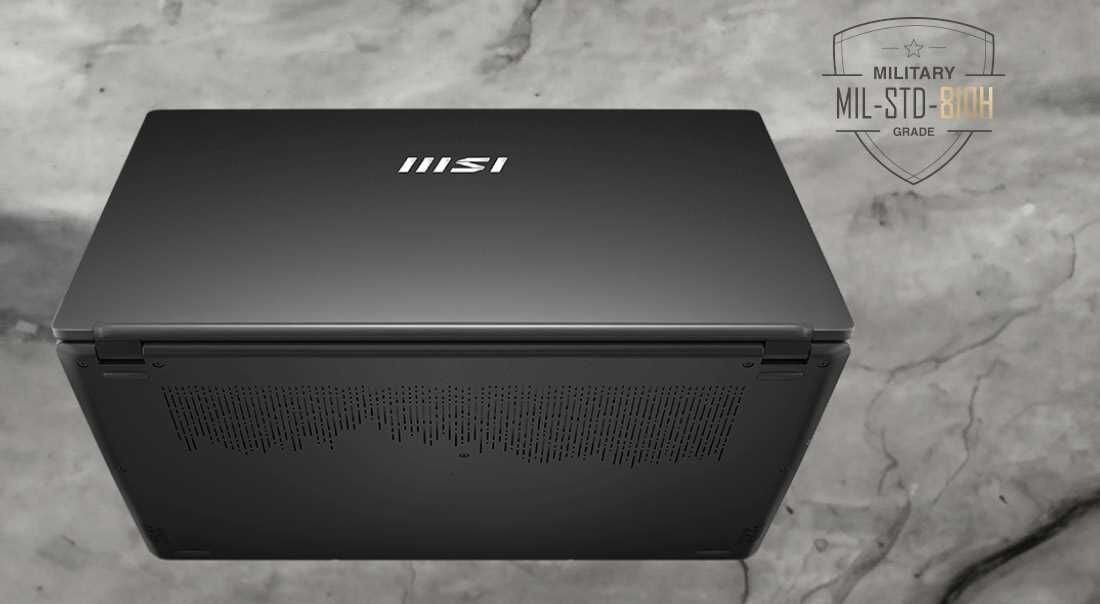 Laptop MSI Modern 15 H AI C1MG - Na marmurowej powierzchni znajduje się laptop MSI, łączący styl z wytrzymałością.