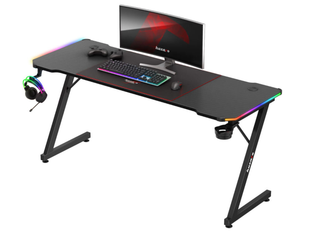 Biurko gamingowe HUZARO Hero 4.8 RGB Czarny prezentacja biurka od prozdu pod kątem na białym tle paski LED klimat dobry wpływ na widoczność działanie relaksujące dla oczu komfort