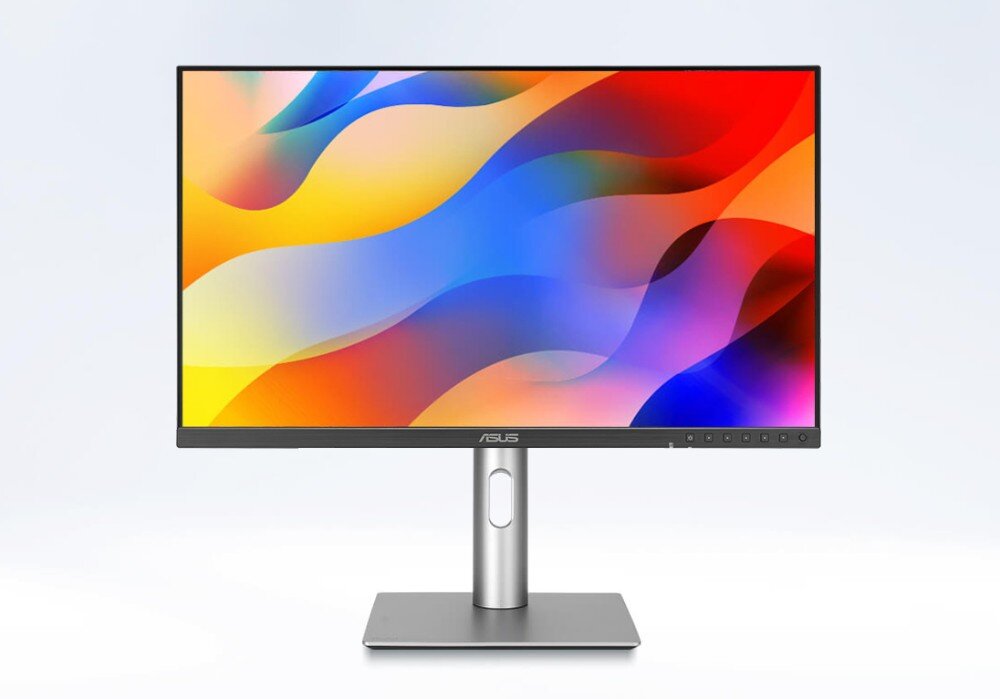 Monitor ASUS ProArt PA24ACRV Monitor komputerowy widoczny od przodu na prostokątnej podstawie z pionową nogą z owalnym otworem na kable. Na ekranie widźne są kolorowe fale