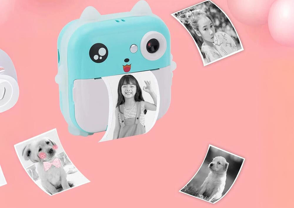 Drukarka EXTRALINK EPP-004 Złącze USB Niebieski aparat natychmiastowy drukujący czarno-białe zdjęcie, na różowym tle z balonami i innymi wydrukowanymi zdjęciami