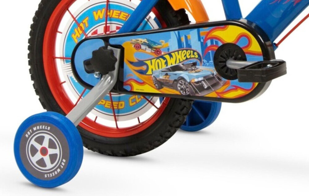 Rower dziecięcy TOIMSA Hot Wheels 16 cali dla chłopca Niebiesko-czerwony zbliżenie na kółka boczne i osłonę łańcucha zdjęcie na białym tle boczne kółka asekurują dziecko w początkowej fazie nauki boczne kółka można łatwo usunąć osłona łańcucha grafika z samochodami zabezpiecza łańcuch przed brudem