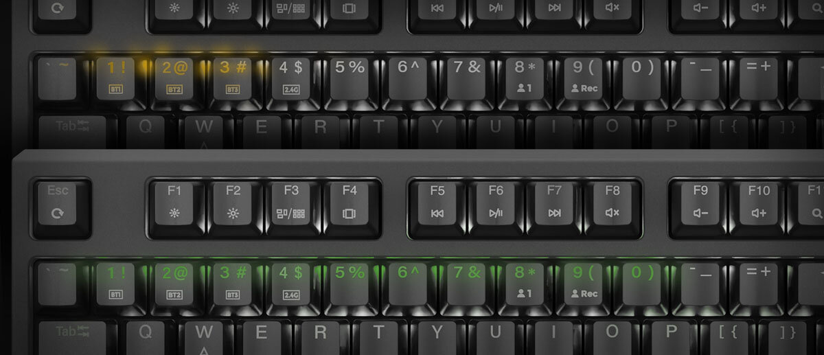 GENESIS Thor 230 TKL Wireless RapidSpeed™ Wireless Obsługa Bluetooth klawiaturę z kilkoma urządzeniami przełączać się między nimi skrótem klawiszowym - Zbliżenie na dwa rzędy klawiatury komputerowej z podświetlonymi klawiszami w różnych kolorach.