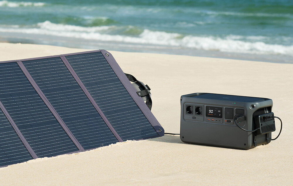 Panel solarny DJI Zignes 120W, energia, mobilność, zasilanie, Panel rozstawiony na plaży w słoneczny dzień, podpięta do niego stacja zasilania, w tle morze