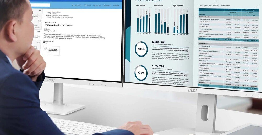 Komputer MSI Pro AP242P 14M-691EU Mężczyzna w garniturze siedzi przy biurku i patrzy na dwa monitory, na których widoczne są wykresy finansowe i wiadomość e-mail, opis