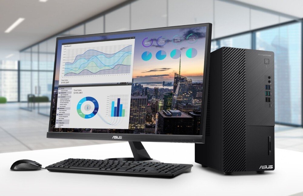 Komputer ASUS ExpertCenter D700ME-513500091X Komputer stacjonarny ASUS z monitorem, klawiaturą i myszką na białym biurku w nowoczesnym biurze. Na ekranie wykresy sprzedaży i panoramy miasta, opis