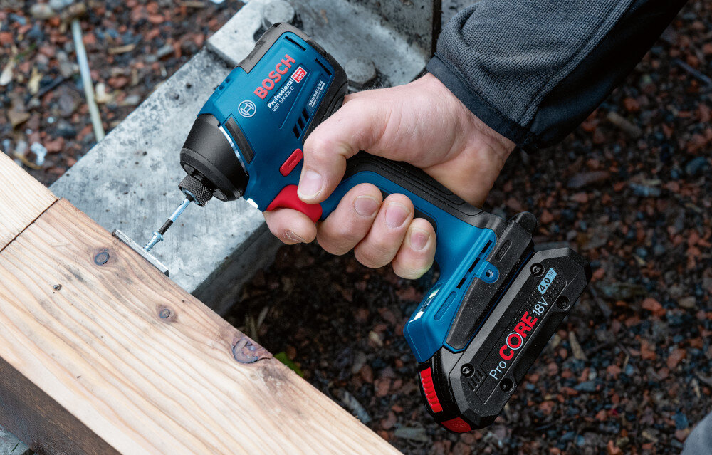 Klucz udarowy BOSCH Professional GDR 18V-220 C 06019L6000 podest osoba przykręca śrubkę do podestu widok z boki od góry wymiary klucza 77 x 113 x 201 mm praca w miejscach o ograniczonej przestrzeni łatwiej manewrować narzędziem smukła, dobrze wyważona konstrukcja antypoślizgowy miękki materiał stabilność chwytu ogranicza ślizganie się dłoni