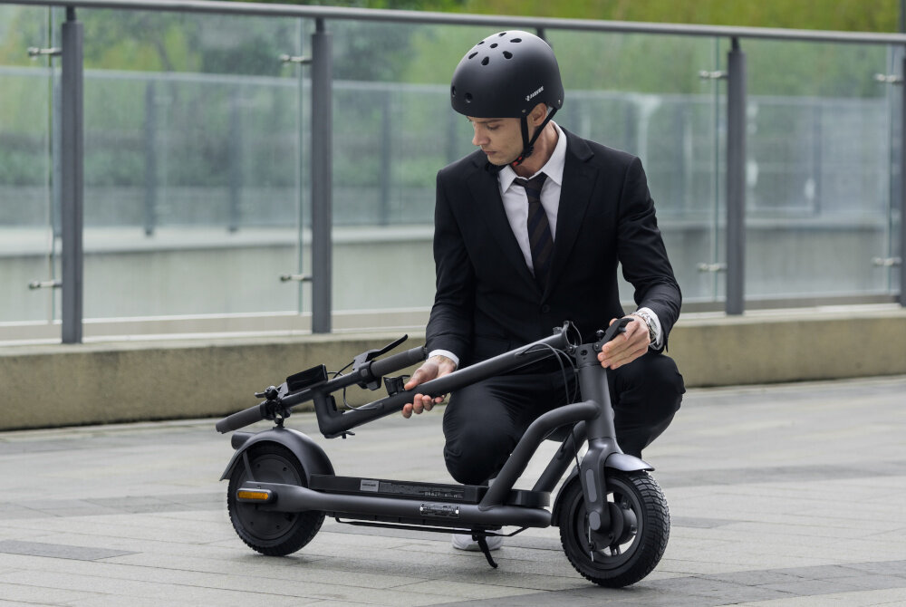 Hulajnoga elektryczna NAVEE N65I 65 km 450W 10.5—Czarny osoba składa hulajnogę stylowy design funkcjonalność bezpieczeństwo na wysokim poziomie komfortowe poruszanie się po mieście wolność wygodna jazda szybka zwrotna