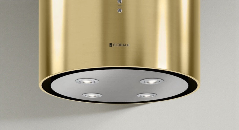 OKAP GLOBALO CYLINDRO ISOLA 39.7 Złoty mat Zdjęcie przedstawia okap kuchenny w kształcie złotej tuby firmy Globalo, widziany od dołu. Na spodzie urządzenia znajdują się cztery wbudowane lampki LED rozmieszczone symetrycznie. W tle widoczne są elementy kuchni: zlew, rośliny w doniczkach, drewniane deski oraz piekarnik. Kompozycja podkreśla elegancki wygląd, solidne wykonanie i funkcjonalne oświetlenie okapu światło power led 4200k regulacja barwy światła 2900k 6300k oświetlenie kuchenne dopasowanie nastroju okap oświetlenie robocze oświetlenie