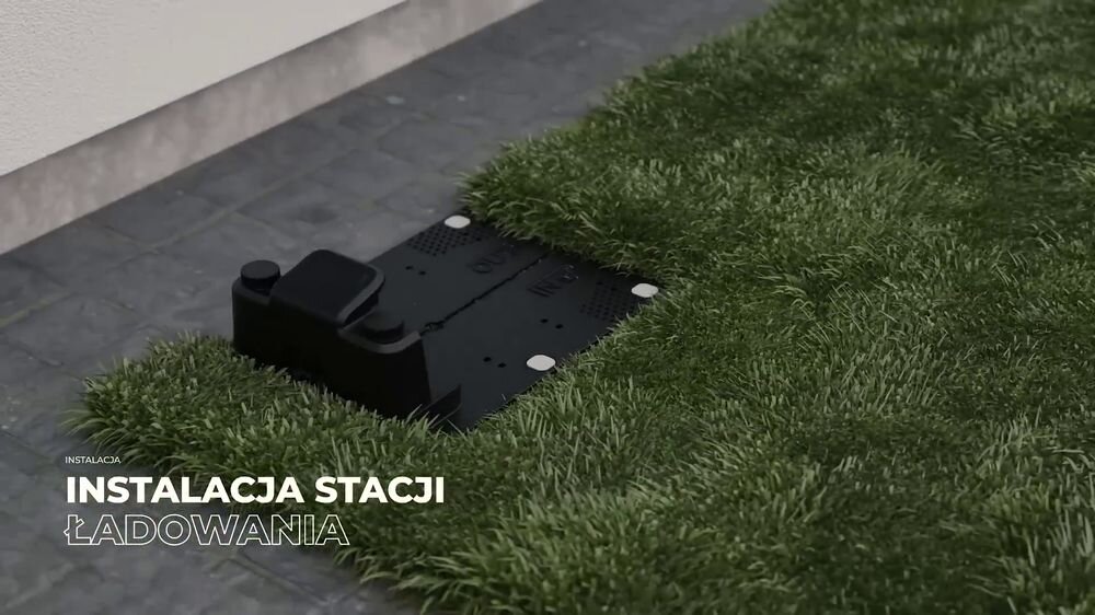 Robot koszący STALCO Perfect RMP2000US sterowanie Bluetooth/Wi-Fi 2000m2, stacja, ładowanie, przewód, instalacja, Stacja ładująca robota koszącego zamontowana w trawie.
