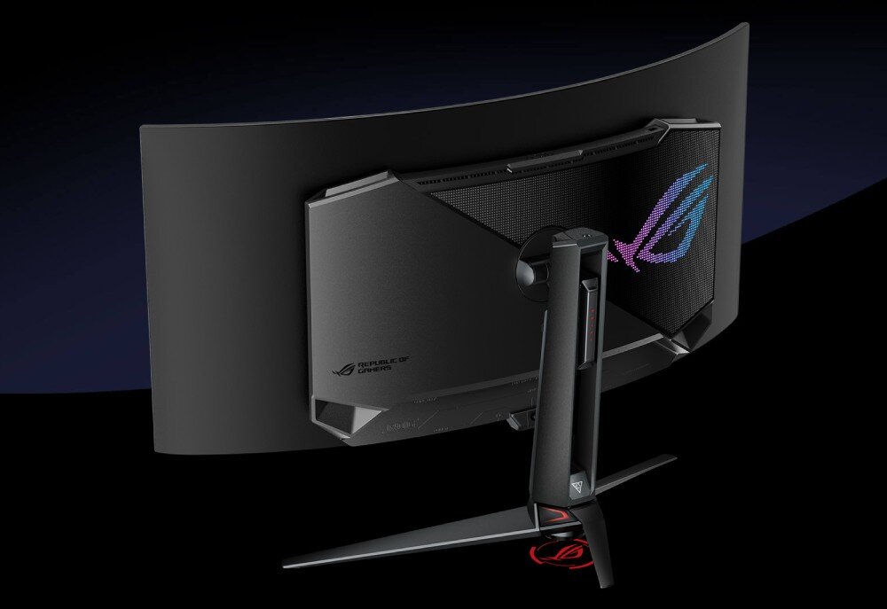 Monitor ASUS ROG Swift PG39WCDM Widok z tyłu na zakrzywiony monitor z futurystycznym designem. Na obudowie znajduje się podświetlane logo oraz otwory wentylacyjne. Monitor stoi na stabilnej podstawie z podświetleniem LED, wygląd, styl, ramka