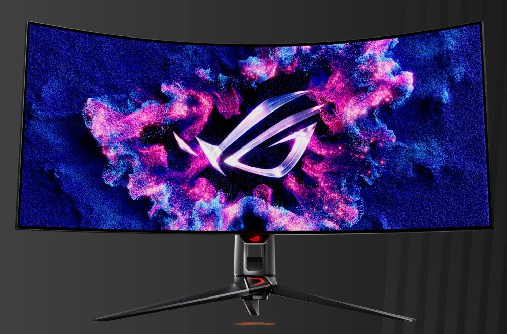 Monitor ASUS ROG Swift PG39WCDM Monitor na biurku z podświetlonym logo na ekranie, otoczonym efektami różowo-niebieskich chmur. W dolnym rogu ekranu widnieje kolorowy emblemat z napisem OLED, jednolita jasność