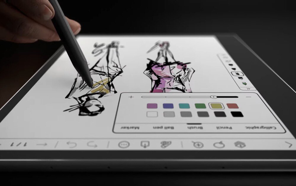 Czytnik e-booków POCKETBOOK InkPad Eo Zbliżenie na rękę rysującą rysikiem na ekranie czytnika. Wyświetlany jest szkic dwóch postaci oraz paleta kolorów do edycji, ekran, przekątna, kolory, odcienie szarości, rozdzielczość