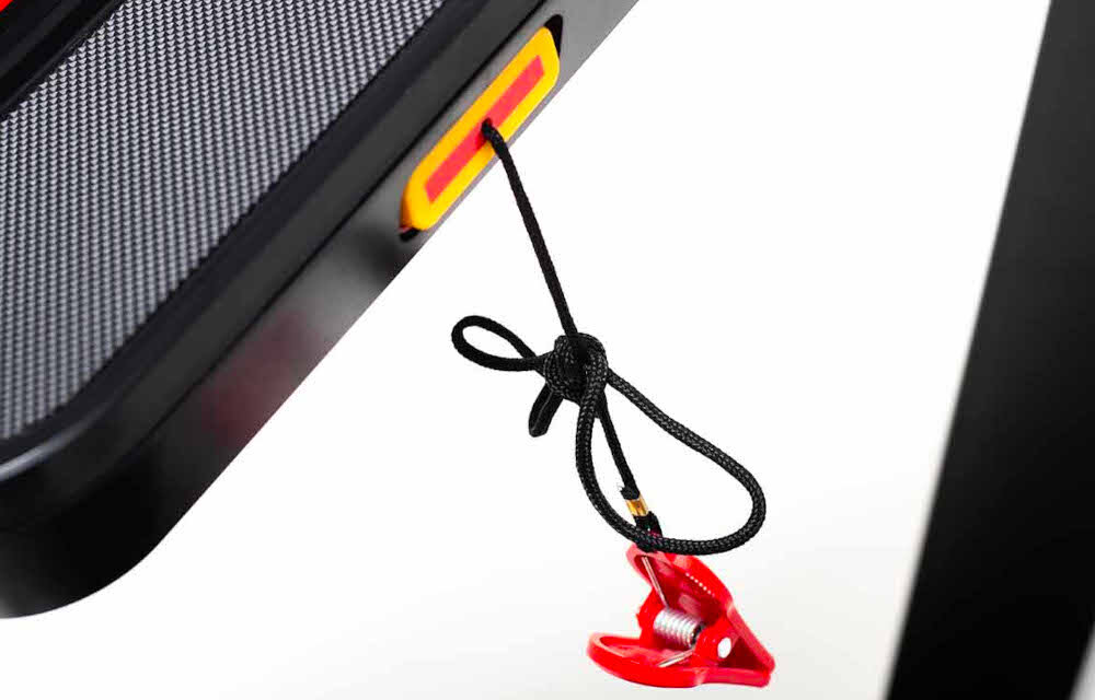 Bieżnia elektryczna YORK FITNESS HT5 1470W 18km-h zbliżenie na klucz bezpieczeństwa klucz zawieszony na bieżni białe tło klucz bezpieczeństwa z praktycznym klipsem ochrona użytkownika podczas treningu klucz automatycznie zatrzymuje pracę urządzenia łatwe przypięcie linki do odzieży wyższy poziom bezpieczeństwa