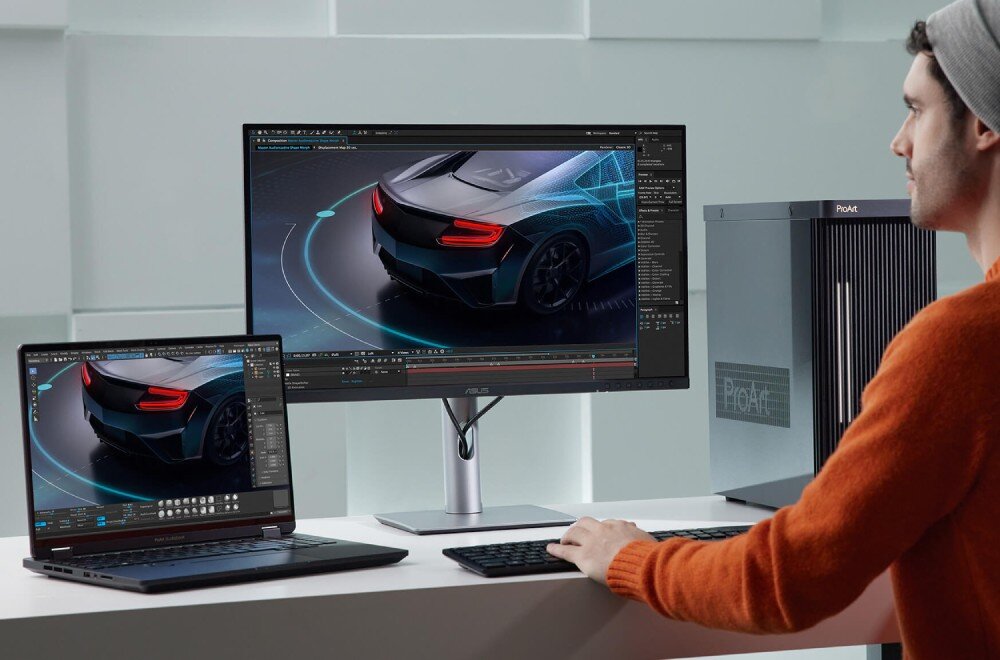 Monitor ASUS ProArt PA278CFRV Mężczyzna pracujący przy biurku z laptopem i monitorem wyświetlającym grafikę 3D samochodu. Obok znajduje się stacja robocza, czujnik światła, jasność, HDR, kontrast