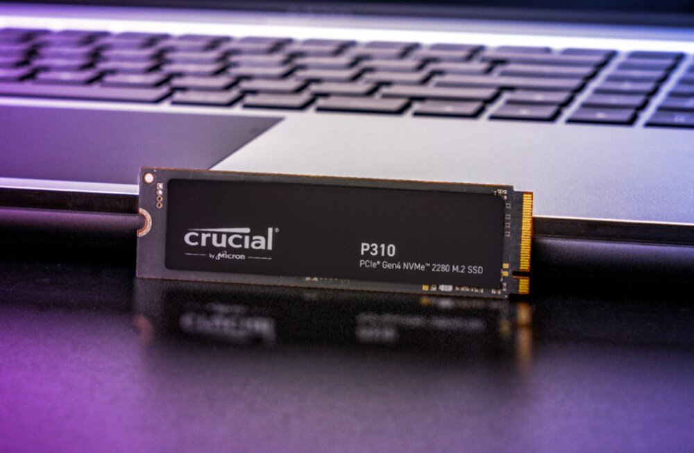 Dysk CRUCIAL P310 Dysk SSD z napisem 'crucial P310 PCIe Gen4 NVMe 2280 M.2 SSD' oparty o obudowę otwartego laptopa, konstrukcja, działanie
