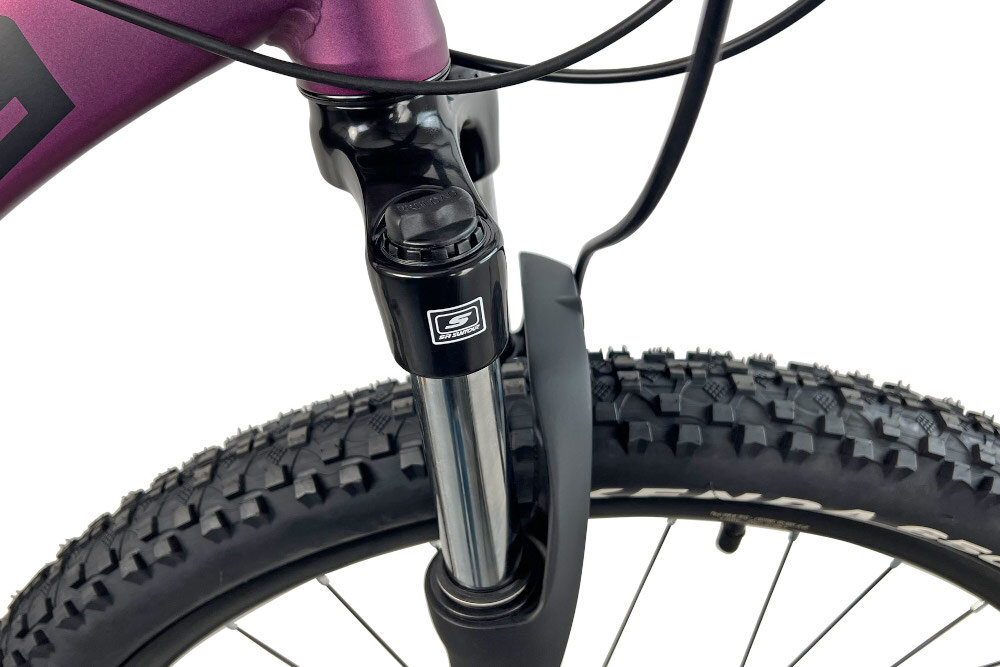 Rower górski MTB INDIANA X-Pulser 3.7 D19 27.5 cala damski Fioletowy zbliżenie na amortyzator rower typu hardtail przedni amortyzator marki SUNTOUR typu XCE-28 DS 27.5 ułatwia najeżdżanie na przeszkody niweluje wstrząsy niska masa roweru duża sztywność regulacja za pomocą sprężyny obsługa poprzez manetki