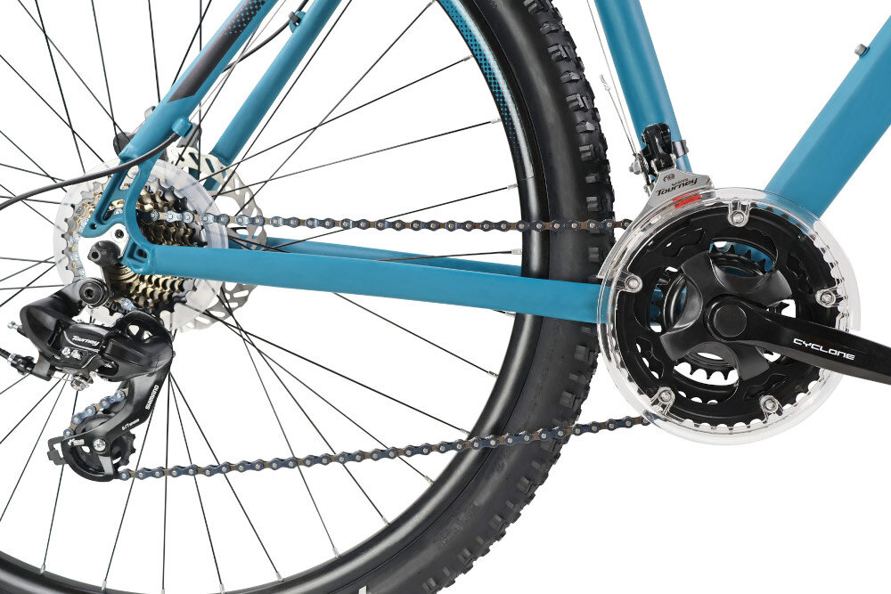 Rower górski MTB INDIANA X-Pulser 1.9 M23 29 cali męski Błękitny zbliżenie na korbę wolnobieg i łańcuch lekka wydajna konstrukcja korby korba CYCLONE typu 24/34/42T wolnobieg SHIMANO typu MF-TZ500 14-28 7 Speed solidność wytrzyma bardzo duży nacisk na pedały