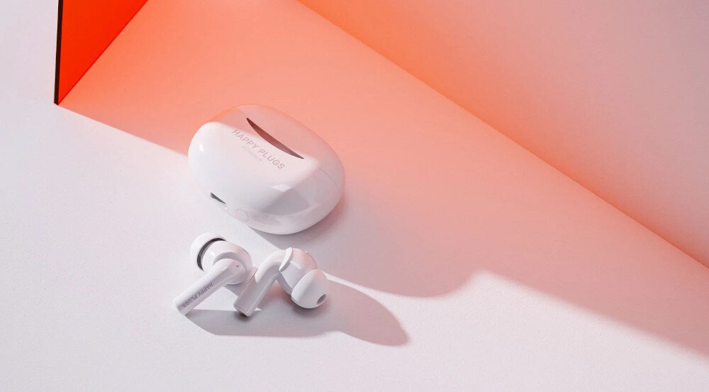 Słuchawki dokanałowe HAPPY PLUGS Joy Pro - Rozmowy bez zakłóceń, słuchawki z etui ładującym na białym blacie