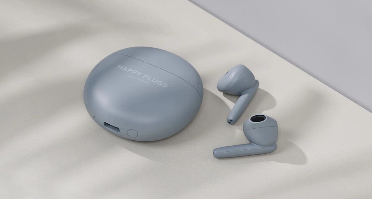 Słuchawki douszne HAPPY PLUGS Joy Lite - Czysty dźwięk i rozmowy, słuchawki z etui leżące na tkaninie