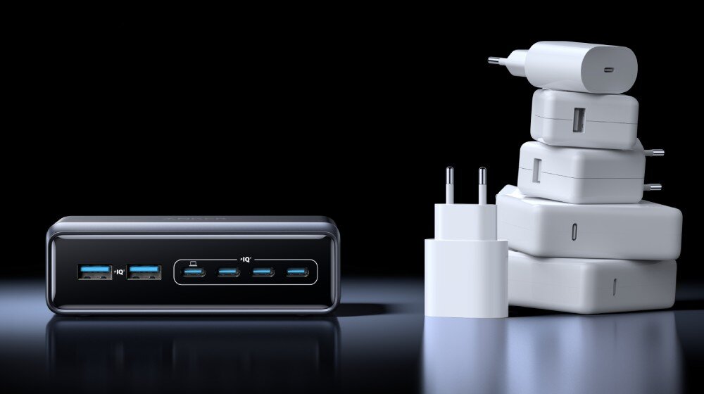 Zasilacz do laptopa ANKER Prime GaN 200W Stacja ładująca z widocznymi portami USB i USB-C ustawiona obok stosu białych zasilaczy sieciowych, działanie, przeznaczenie, moc