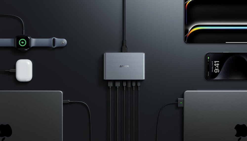 Zasilacz do laptopa ANKER Prime GaN 200W Stacja ładująca podłączona do kilku urządzeń elektronicznych, w tym laptopa, smartfonów, smartwatcha i słuchawek bezprzewodowych, rozmieszczonych na ciemnym blacie, porty, podłaczenie