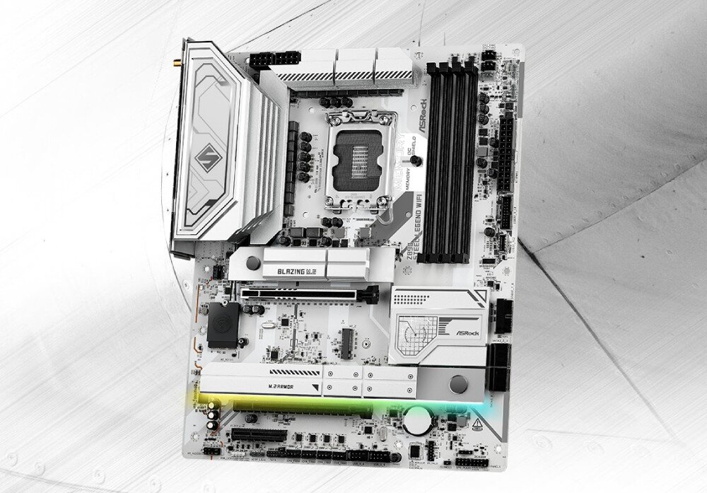 Płyta główna ASROCK Z890 Steel Legend WiFi Widok płyty głównej w kolorystyce biało-srebrnej z widocznym gniazdem procesora, czterema slotami pamięci RAM oraz osłonami radiatorów, opis