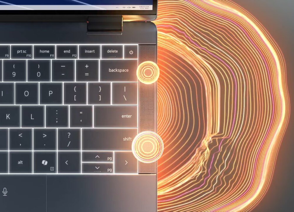 Laptop DELL Latitude 9450 Fragment klawiatury laptopa i dwóch głośników z wizualizacją fal dźwiękowych rozchodzących się na zewnątrz w postaci kolorowych linii, głośniki, dźwięk, audio, mikrofony