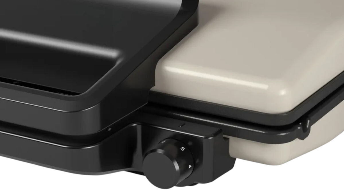 Grill elektryczny BOSCH TCG3302, szybkie nagrzewanie, efektywne grillowanie, lampka kontrolna, odprowadzanie tłuszczu, Detal na pokrętło regulacji temperatury w grillu BOSCH TCG3302, fragment dolnej obudowy i uchwytu, minimalistyczny styl