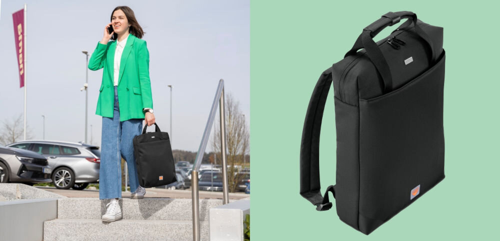 Plecak do laptopa HAMA Extreme Protect 16.2 cali Czarny prezentacja plecaka od przodu pod kątem na zielonym tle obok dziewczyna idąca po schodach z plecakiem w ręce rozmawiająca przez telefon bezpieczne przymocowanie plecaka do uchwytu walizki wygoda ochrona praca podróż służbowa