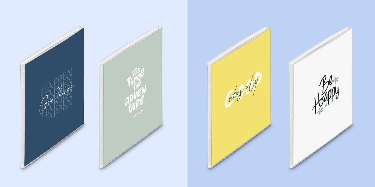 Cztery albumy w różnych kolorach: granatowy z napisem \'HAPPEN Good Things HAPPEN\', szary z napisem \'it\'s Time for a new adventure\', żółty z napisem \'Color up\', biały z napisem \'Be Happy\'.