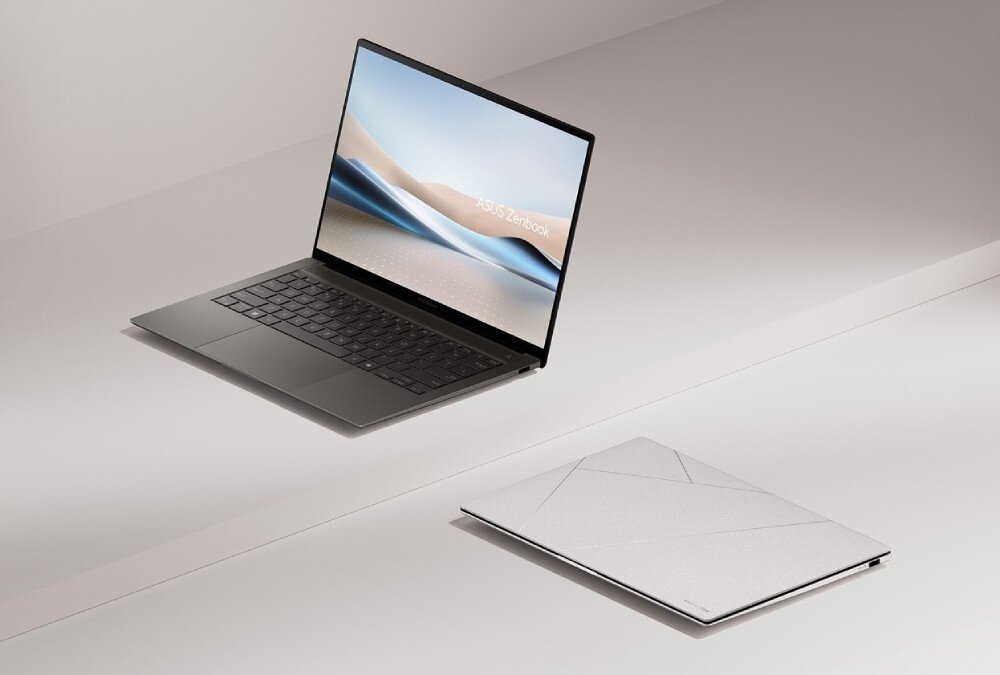 Laptop ASUS ZenBook S 14 UX5406SA-PV030W Otwarty laptop stojący na blacie, obok niego drugi egzemplarz tego samego modelu zamknięty, widoczny z góry, opis