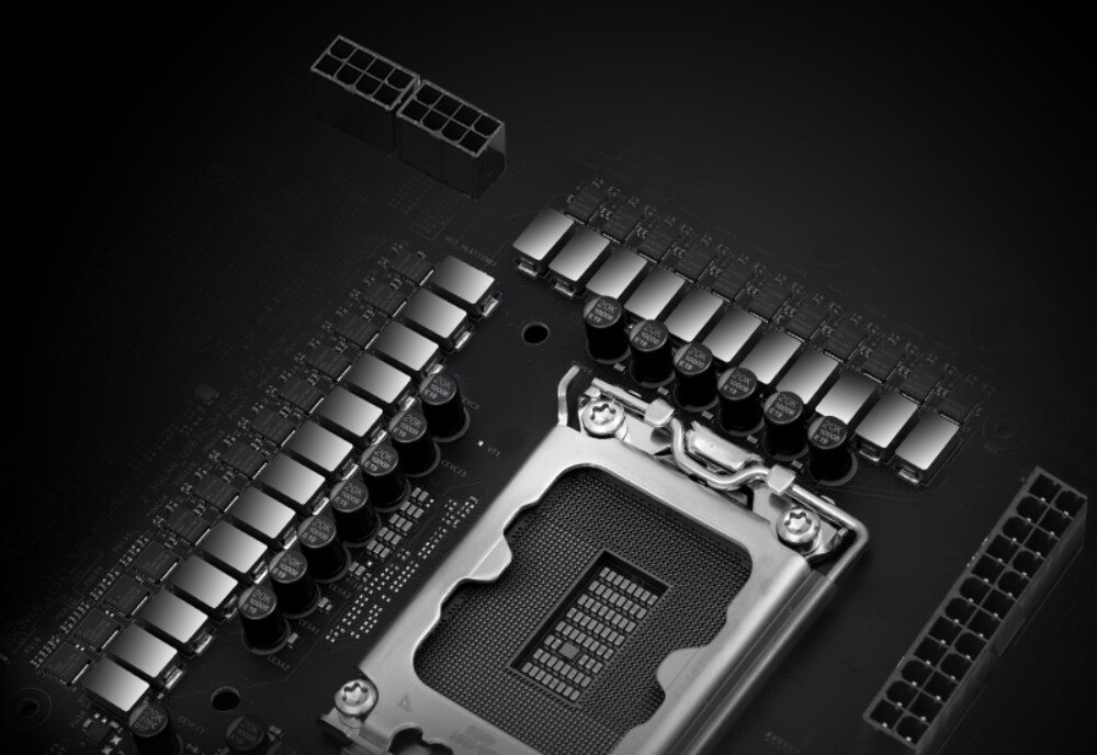 Płyta główna ASROCK Z890 Taichi Lite Zbliżenie na sekcję zasilania płyty głównej, ukazujące rzędy srebrno-czarnych kondensatorów otaczających metalowe gniazdo procesora