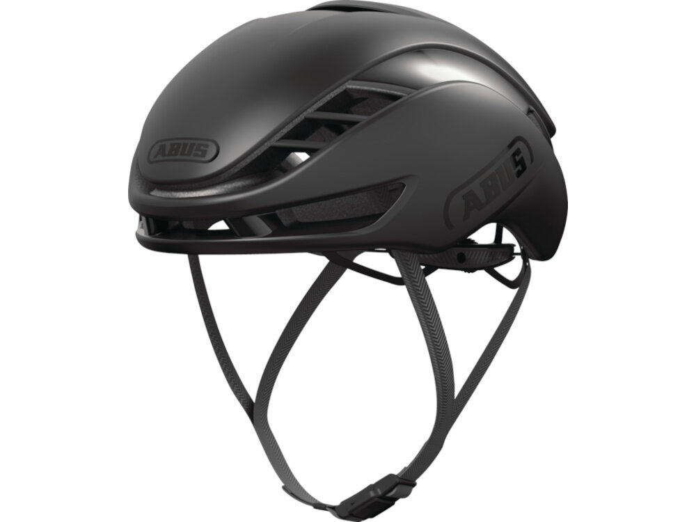 Kask rowerowy ABUS Gamechanger Velvet Czarny Szosowy rozmiar L, 59-62 cm kask na białym tle widoczny od przodu pod skosem paski Flow Straps Pro ogranicza opór przepływu i hałas cienka górna część zapięcie na zatrzask miękkie poduszki mają mocowanie na rzepach przedni i tylny uchwyt na okulary