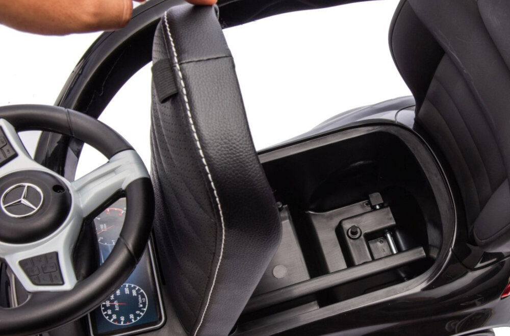 Jeździk MILLY MALLY Mercedes Benz C-Class Deluxe Czarny zbliżenie na schowek osoba podnosi siedzisko pojemny schowek do przechowywania zabawek lub drobiazgów