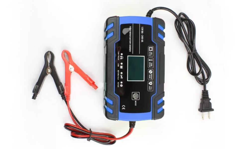 Prostownik EXTRALINK kompaktową obudowę 17 × 9 × 6 cm garażu, warsztacie bagażniku samochodu - prostownik od góry na białym tle