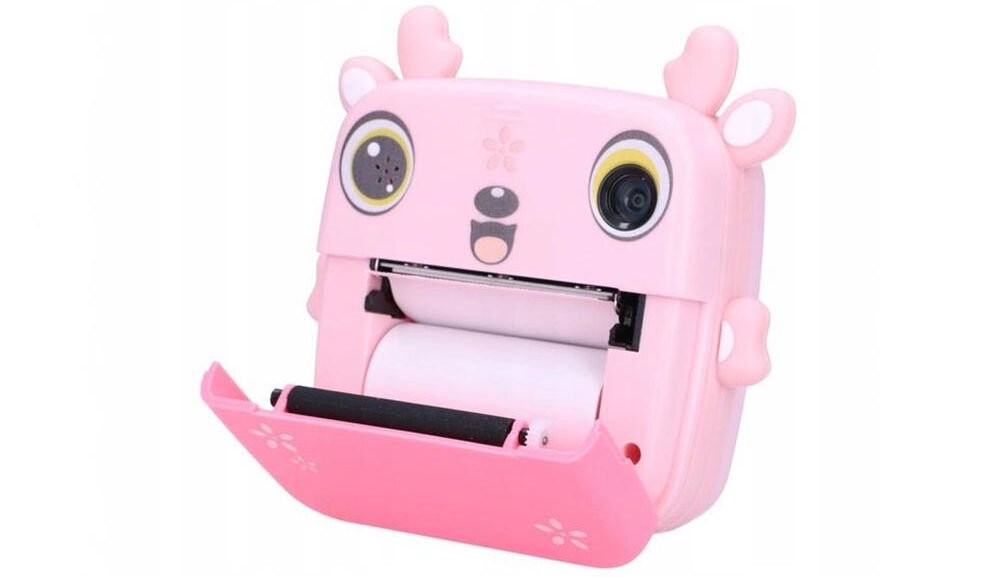 Drukarka EXTRALINK EPP-005 Złącze USB Różowy + Papier termiczny zwykły (3 szt.) Zbliżenie na aparat natychmiastowy z otwartą przednią klapką, pokazujące rolkę papieru termicznego wewnątrz wbudowany aparat połączenie z modułem drukującym eliminacja potrzeby przesyłania plików