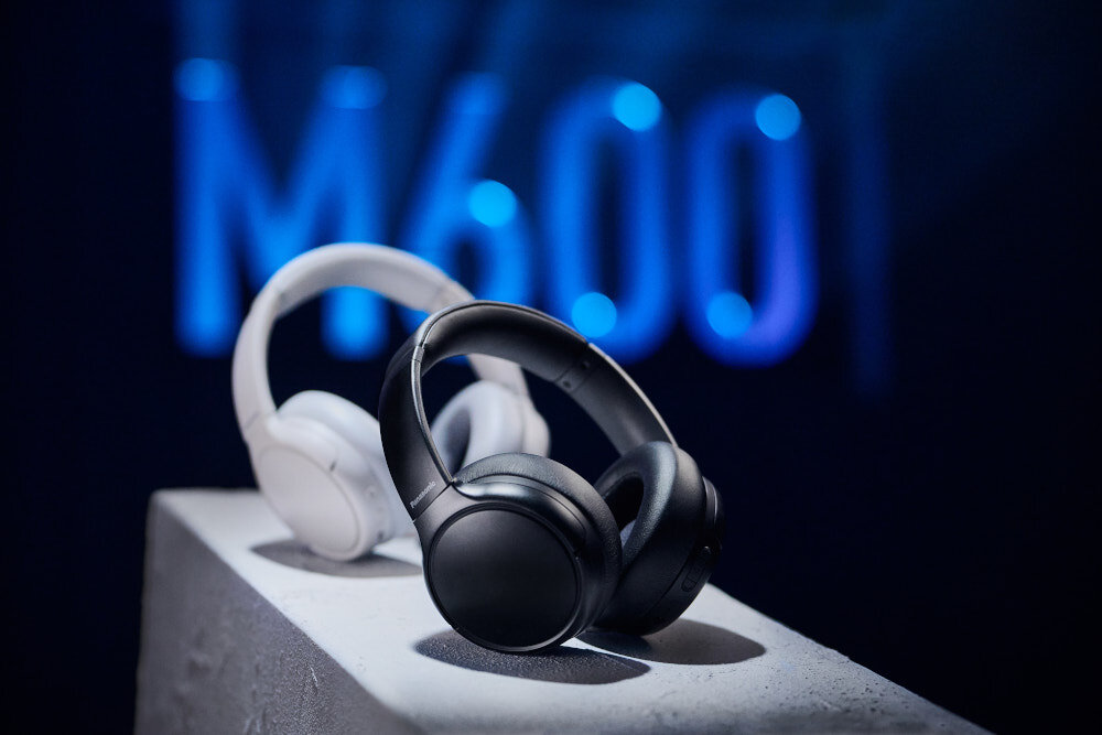 Słuchawki nauszne PANASONIC RB-M600BE-C - Wygoda i moc w każdej podróży, dwie pary słuchawek nausznych na białym postumencie na ciemnym tle