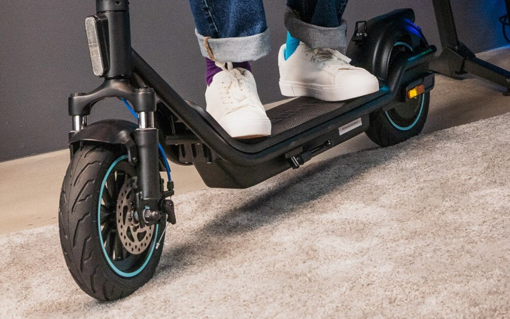 Hulajnoga elektryczna ACER PREDATOR Series ES Storm 60km 500W Amortyzacja 10 cali Czarny osoba stoi dwoma stopami na podeście zbliżenie na podest stylowy design wyjątkowa wytrzymałość wysoka wydajność rama z wysokiej jakości stopu aluminium odporna na intensywne użytkowanie obciążenie do 120 kg duży, antypoślizgowy podest