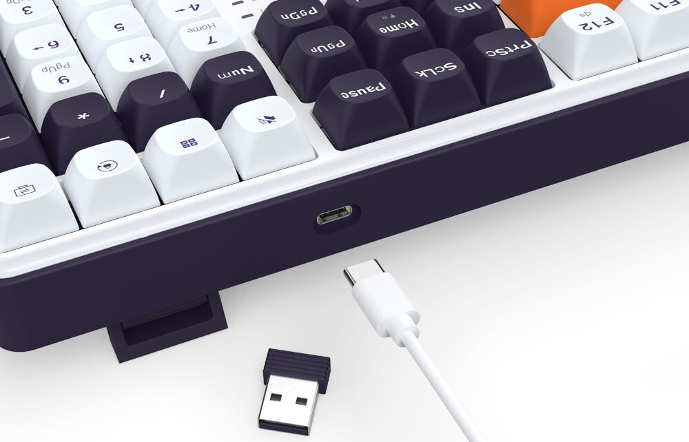 Klawiatura K689WBO-RGB-PRO Wyvern wszechstronność połączeń dzięki trzem różnym trybom
połączenia - tryb bezprzewodowy 2,4 GHz, Bluetooth, przewodowy za pomocą odłączanego kabla USB-A / USB-C o długości 1,5 m
(przewód w zestawie)
wbudowany akumulator o pojemności 4000 mAh oferujący do kilku dni pracy bez potrzeby ładowania, produkt na białym tle,
kabel zakończony wtyczką USB-C, adapter USB-A 2,4 GHz,