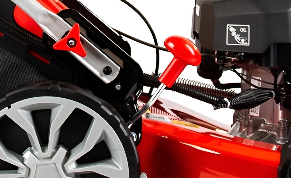 Kosiarka spalinowa GREENSO KS53-G224NE zbliżenie na dźwignię do regulacji wysokości koszenia koszenie z uwzględnieniem preferowanej wysokości trawy w zakresie 25-75 mm centralna regulacja koszenia 7-stopniowa skala