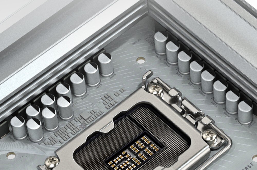 Płyta główna GIGABYTE B860 Aorus Elite WiFi 7 Ice Zbliżenie na puste gniazdo procesora otoczone rzędami srebrnych kondensatorów na jasnym laminacie płyty głównej