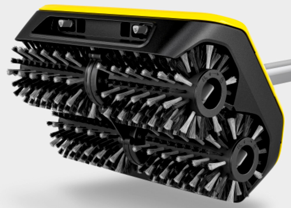 Obraz przedstawia głowicę urządzenia do czyszczenia posadzek z dwoma obrotowymi szczotkami. Obudowa jest w kolorze czarno-żółtym.