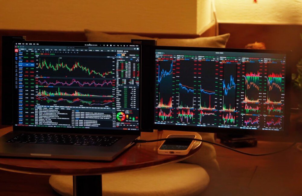 Monitor EXTRALINK Smart Life S3 Laptop z podłączonym dodatkowym ekranem pokazującym wykresy giełdowe w ciemnym otoczeniu, zasilanie, zużycie energii