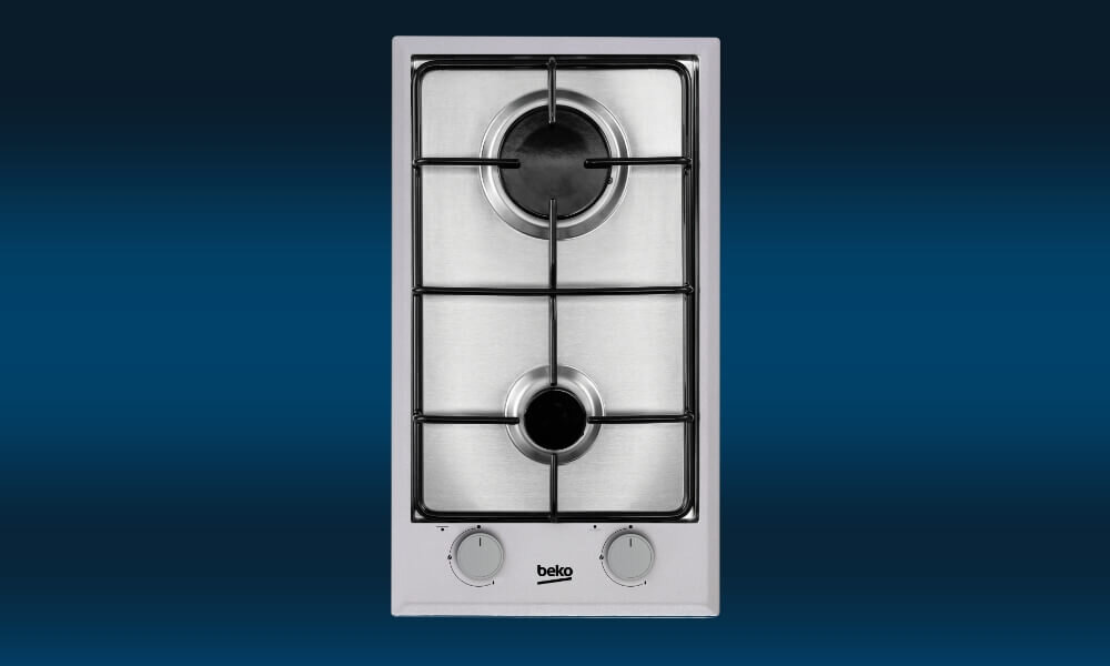 PŁYTA BEKO HDCG 32220 SX Na grafice przedstawiono srebrną płytę gazową Beko z dwoma palnikami rozmieszczonymi symetrycznie oraz dwoma pokrętłami sterującymi umieszczonymi pionowo po prawej stronie. Urządzenie pokazano na granatowym tle z delikatnym przejściem tonalnym, co eksponuje prostą i funkcjonalną konstrukcję płyty płyta gazowa 30 cm szkło design łatwe czyszczenie 2 palniki