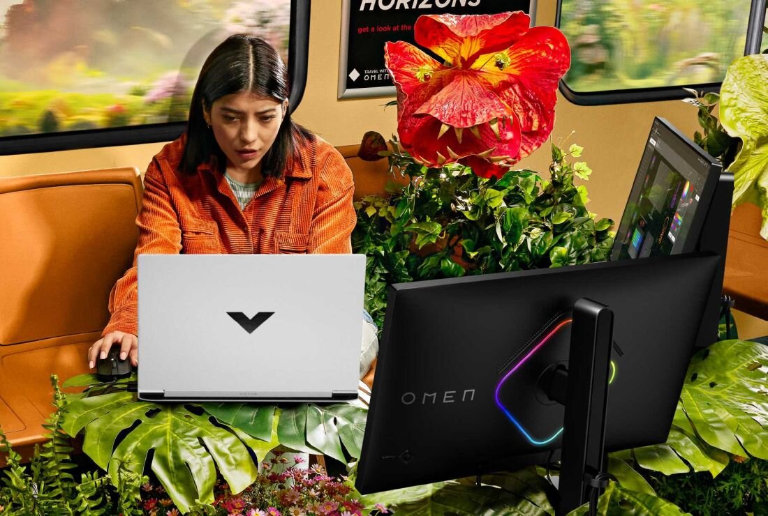 Laptop HP Victus 16 - Kobieta siedząca w pociągu, korzystająca z laptopa, skupiona na pracy lub nauce w podróży.